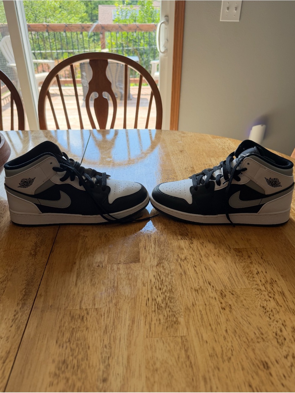 Nike Jordan 1 Black and White Mid-Top Sneakers with Winged Logo